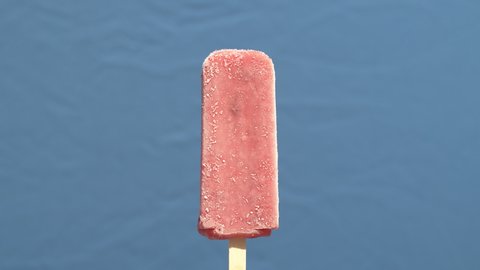 Time lapse closeup of an ice pop melting. Filmed with a blue screen for background ral and compositing.