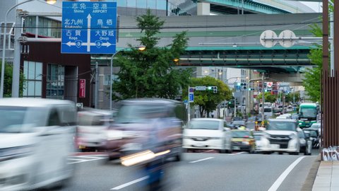 Fukuoka, Japan - 12 July 2019 - Cars and buses stop at traffic intersection on a street in Fukuoka, Japan on July 12, 2019