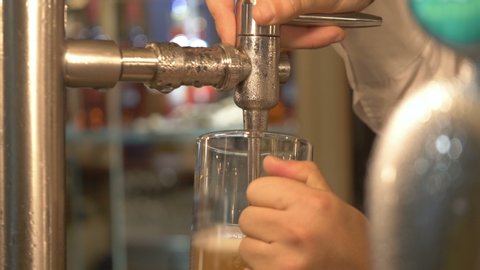 Pouring beer from beer tap in 4k slow motion 60fps