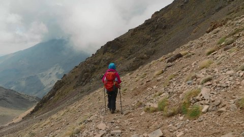 Tourist backpacker hiking in High Atlas mountains, Morocco, tracking