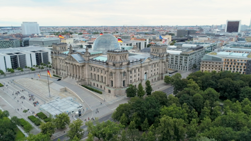 Reichstag (Bundestag) - German Parliament Building with Dome and Berlin Cityscape at the Background, Germany, Europe. Aerial View 4K Panning Shot Royalty-Free Stock Footage #1036182626