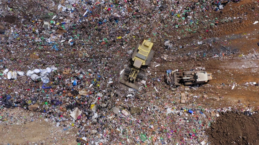 Top down aerial footage of a Municipal Solid waste Landfill during collecting, sorting and pressing work | Shutterstock HD Video #1036184675