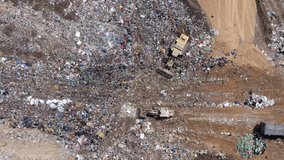 Top down aerial footage of a Municipal Solid waste Landfill during collecting, sorting and pressing work