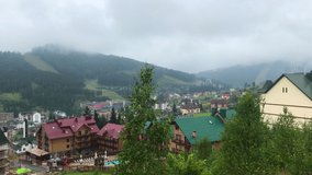 Carpathian mountains Bukovel panorama landscape wonderful green nature and landscapes village houses and chalets different perspective angles travel-tourism sightseeing holiday sky blue white clouds 