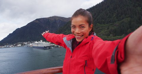 Selfie video - Cruise ship passenger in Alaska city of Ketchikan welcoming smiling hands saying hello looking at camera while sailing Inside Passage. RED EPIC SLOW MOTION.