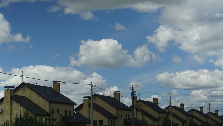 Time lapse of clouds above residential area