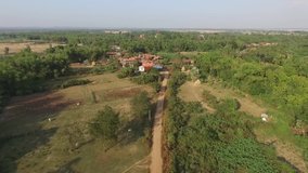 Kampong Cham is a low land province on the Mekong River in Cambodia.Farmers grow tobacco, corn and bananas. These aerial clips show rural buildings elevated on stilts in Han Chey district