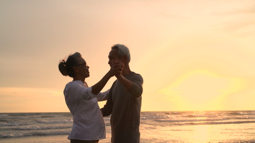 Asian couple senior elder retire resting relax dancing at sunset beach honeymoon family together happiness people lifestyle, Slow motion footage Royalty-Free Stock Footage #1036213991