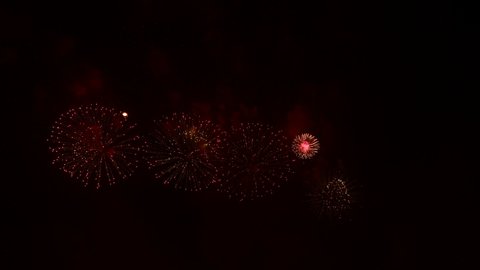 Fireworks light up the sky with dazzling display. Real Fireworks on Deep Black Background.