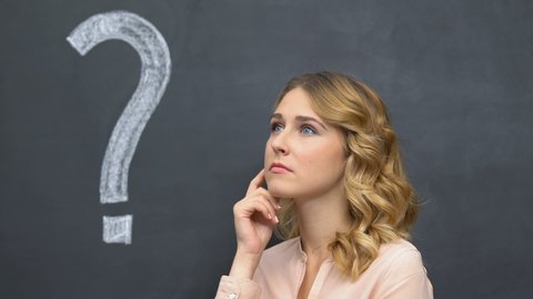 Question mark written on blackboard, pensive woman thinking, making decision
