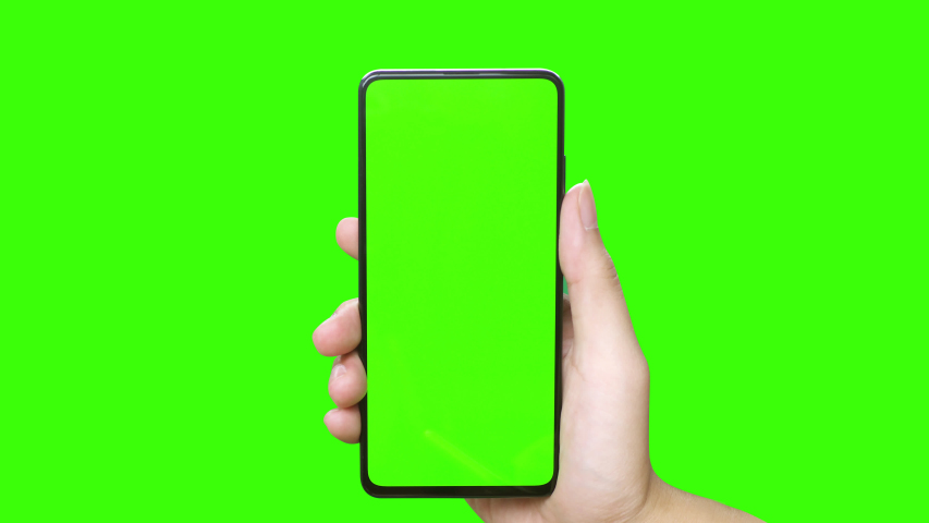 Man's hand holding a mobile telephone with a vertical green screen in tram chroma key smartphone technology cell phone touch message display hand with luma white and black key | Shutterstock HD Video #1036222220