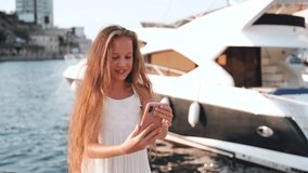 Junior girl making self shot on smartphone