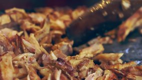 Sliced marinated crispy meat from a grilled Doner kebab ready for serving at a fast food or takeaway venue or market