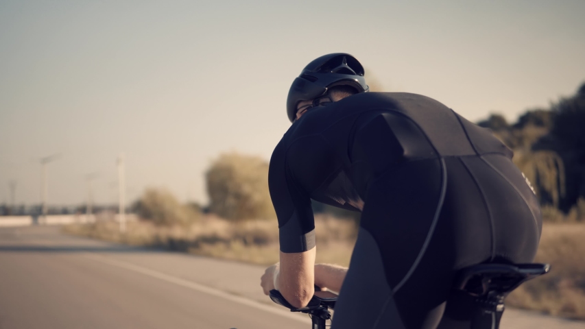 Cyclist Rider In Helmet And Sportswear Riding Workout At Sunset On Triathlon Time Trial Bicycle.Cyclist Professional Fit Man On Triathlon Bicycle.Triathlete Training On Bike.Cycling Exercise On Bike. | Shutterstock HD Video #1036227737