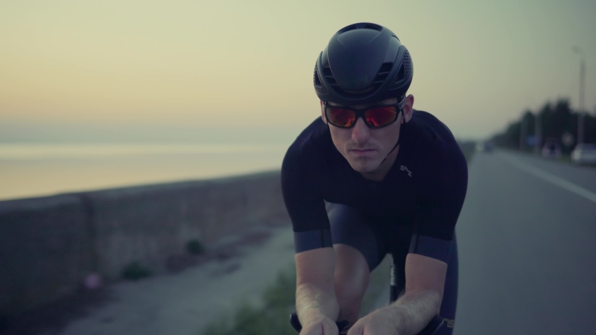 Cyclist Professional Fit Man On Triathlon Bicycle.Cyclist Rider In Helmet And Sportswear Riding Workout At Sunset On Triathlon Time Trial Bicycle.Triathlete Training On Bike.Cycling Exercise On Bike. | Shutterstock HD Video #1036227749