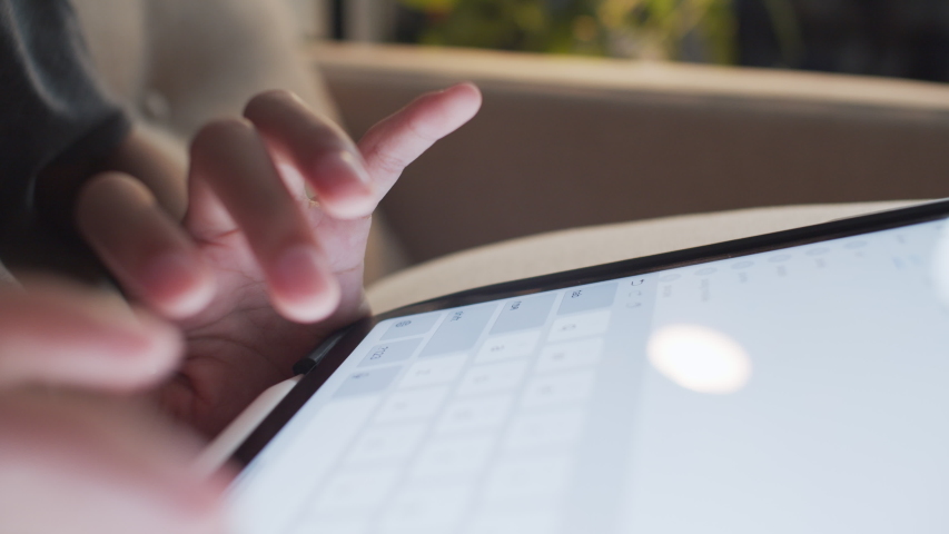 Hand of little girl touching keyboard on modern digital tablet	
