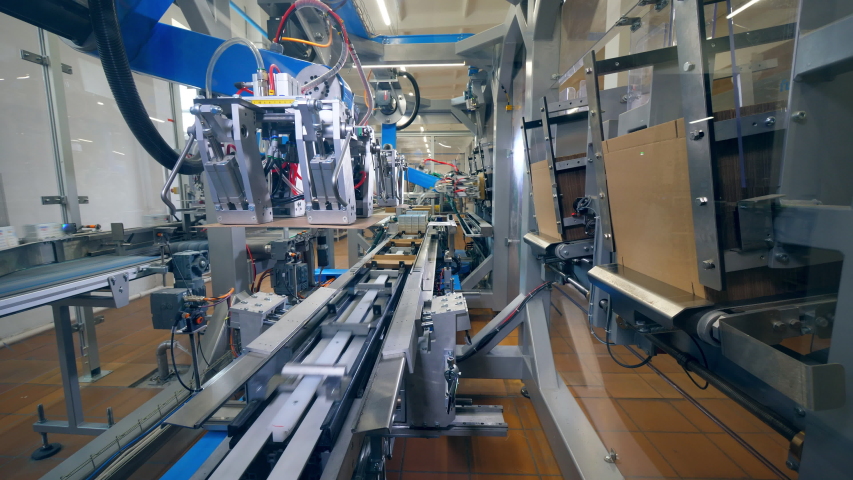 Carton boxes are getting made and relocated by the machine | Shutterstock HD Video #1036232357