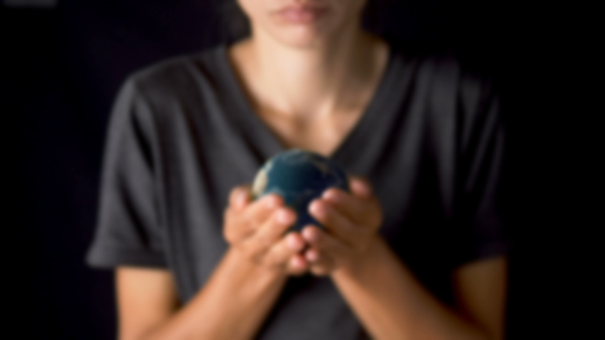 Female hand holding a realistic Earth. Holding the world in your hand. Rotation planet. Earth globe. World map design. Global sphere planet. Texture map courtesy of NASA.