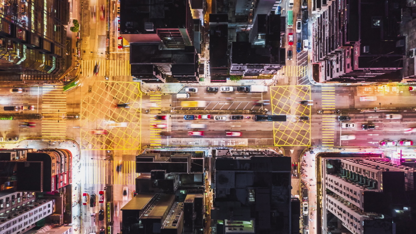 4K UHD Time-lapse of car traffic on road and people crossing street at night in Hong Kong downtown district, drone aerial top view. Commuter, Asia city life, or public transportation concept, Zoom out | Shutterstock HD Video #1036252025