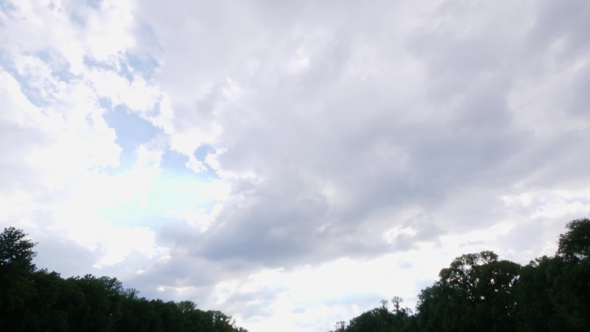 Slow tilt down to the water to the front steps of the Lincoln Memorial taken from the reflection pond with people in the foreground.