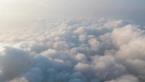 Flying above clouds, view from plane window during flight
