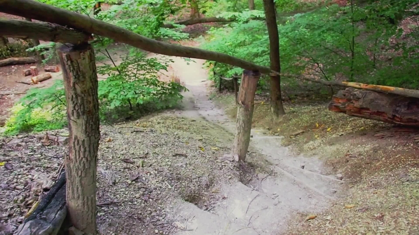 Stairs in the mountains with cut steps in the chalk mountain. Careful steps down a handicraft ladder. Focus from person view. Chalk mountain path, middle plan. Moving camera with effects of steps.