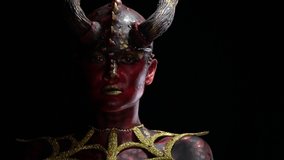 Close up of a demon with red and black skin with scales and long horns - Powered by Shutterstock - Get 15% off with code: PIKWIZARD15