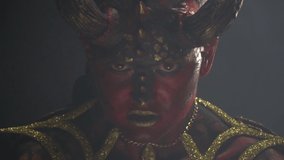 Close up of the evil look of a demon with red skin and big horns - Powered by Shutterstock - Get 15% off with code: PIKWIZARD15