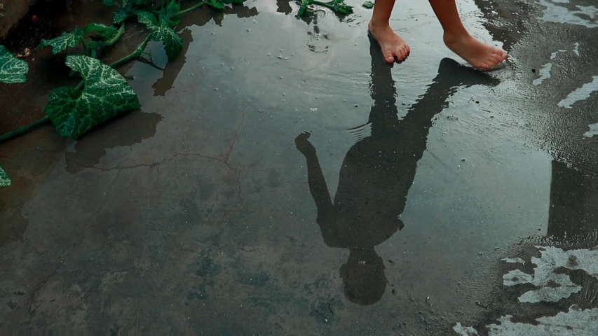 Lonely child playing with feet in water until another child comes to end the loneliness and play with him. bulling child abuse isolated Only child syndrome despair sadness bipolar anxiety depression