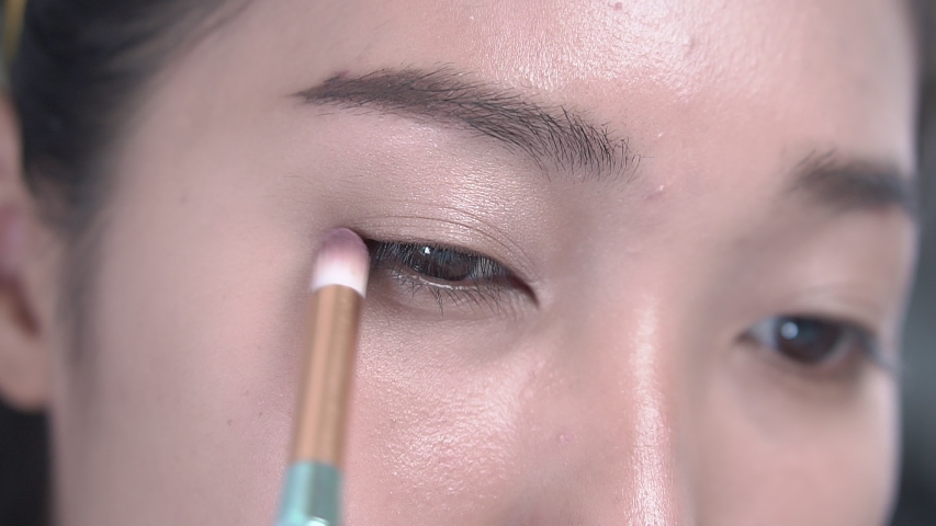 Asian women make up around the eyes. | Shutterstock HD Video #1036279595