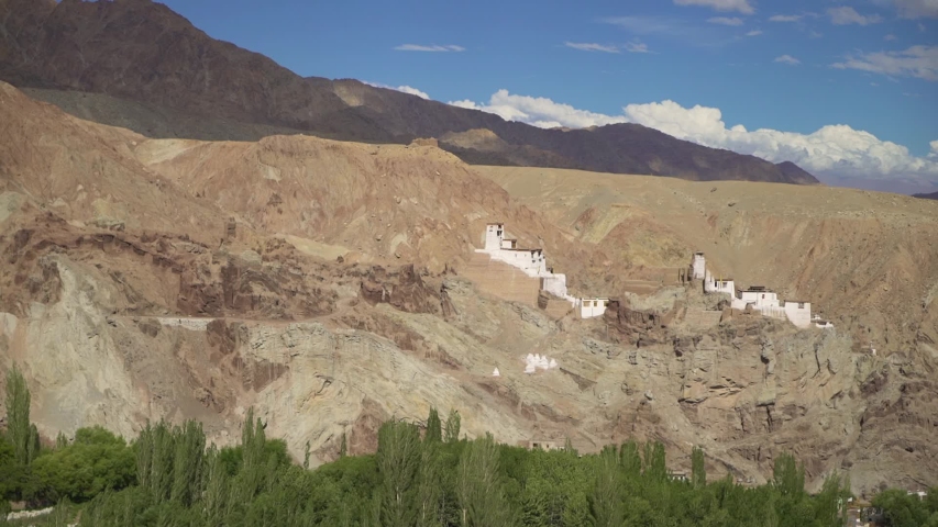 Buddhist Monastery on Hill Over Green Valley in Ladakh India Under Himalayas and Tibet, Cinematic Pan Shot