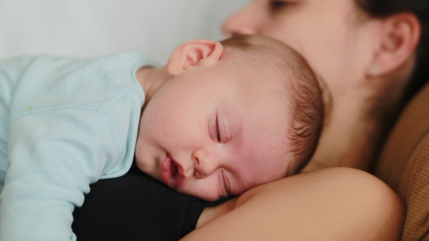 newborn sleeping on chest