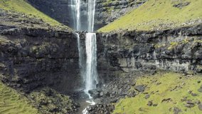 Aerial view of the Fossa Waterfall on island Bordoy. This is the highest waterfall in the Faroe Islands, situated in wild scandinavian scenery. 4K UHD video.