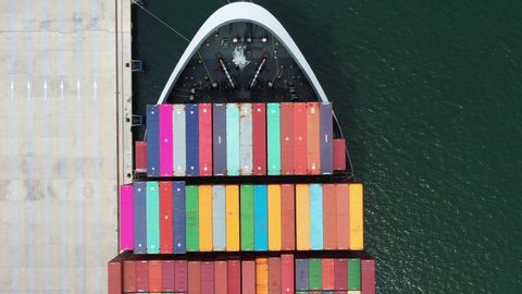 Container ship loading and unloading with industry crane at sea port, Aerial top view business commercial trade logistic import and export freight transportation by container cargo ship in open sea.