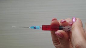 the doctor is holding a syringe. The fight against epidemics, vertical video - Powered by Shutterstock - Get 15% off with code: PIKWIZARD15