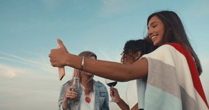 Group of young people having fun at a rooftop party, taking selfie. Focus on the people in the middle. 4k slow motion raw video footage 60 fps