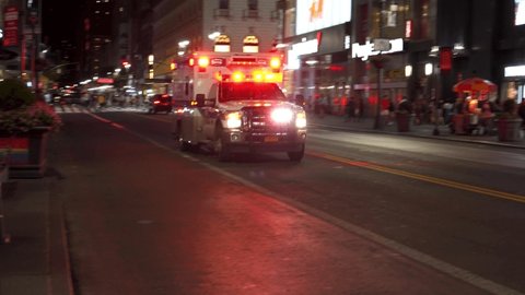 NEW YORK CITY, USA -  22nd of June 2019: An ambulance with siren in New York City at night. Sound included.