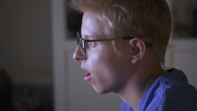 Teen Boy In Glasses Plays  Evening On Computer Games