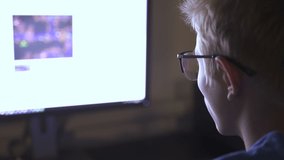 Teen Boy In Glasses Plays  Evening On Computer Games