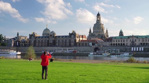 Tourist is taking a picture of the Dresden skyline, Saxony, Germany
