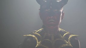 Female demon with red skin and big horns is looking from the smoky room - Powered by Shutterstock - Get 15% off with code: PIKWIZARD15