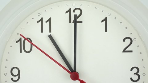 
The beginning of time 11.00 am or pm, Closeup White wall clock Red second hand minute Walk slowly, Time concept.