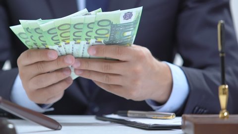 Politician counting euros and hiding in jacket, signing documents, bribery