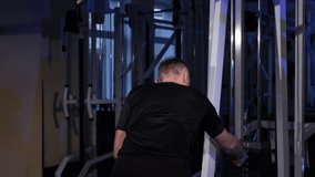 Lat pulldown.A young man does a back muscle exercise on a simulator.copy space - Powered by Shutterstock - Get 15% off with code: PIKWIZARD15