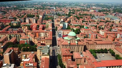 Aerial, drone shot panning towards the Church of the Sacred Heart of Jesus, in middle of Bologna city, on a sunny day, in Toscany, Italy