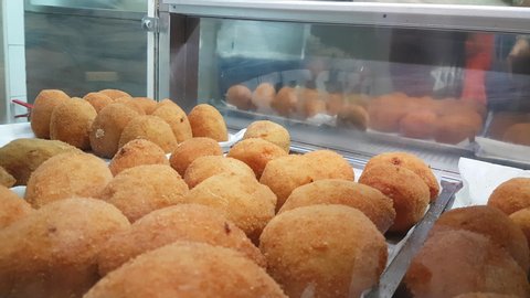 4k Video of Arancini traditional sicilian rice ball in a shop in Taormina Sicily August 2019