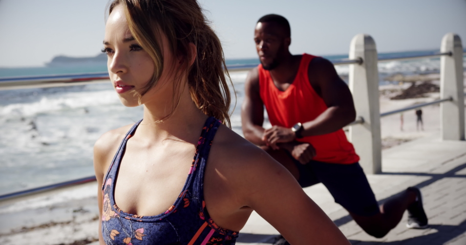 Animation of a young Caucasian woman and a young African American man on a beach, seen on a screen of a digital camera in record mode with icons and timer 4k