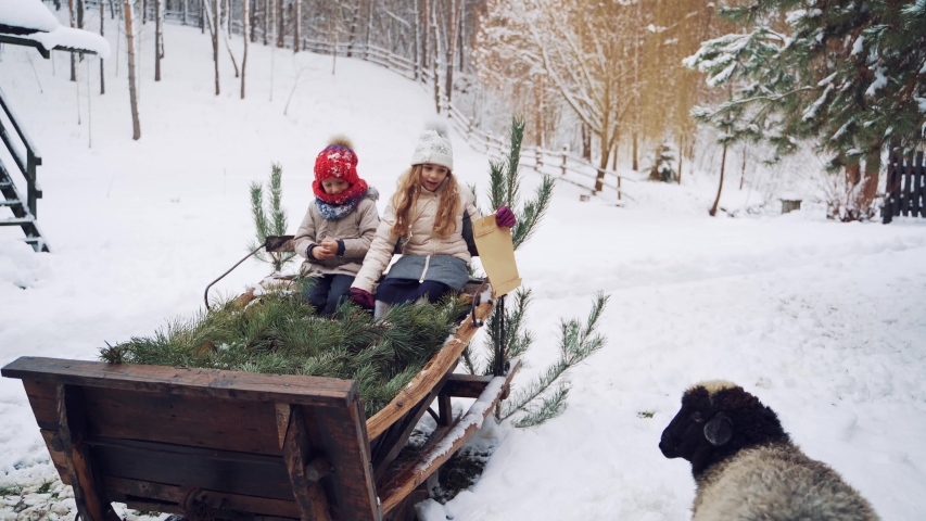 Children on sled of Santa Claus. Two children sitting on the big sled of Santa Claus