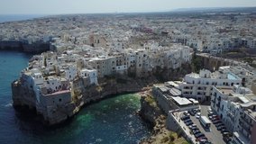 Aerial video shooting with drone on Polignano a Mare, famous Salento city on the Mediterranean sea