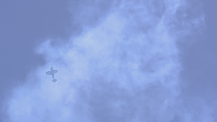 Aerobatic display: airplane various maneuvers with smoke